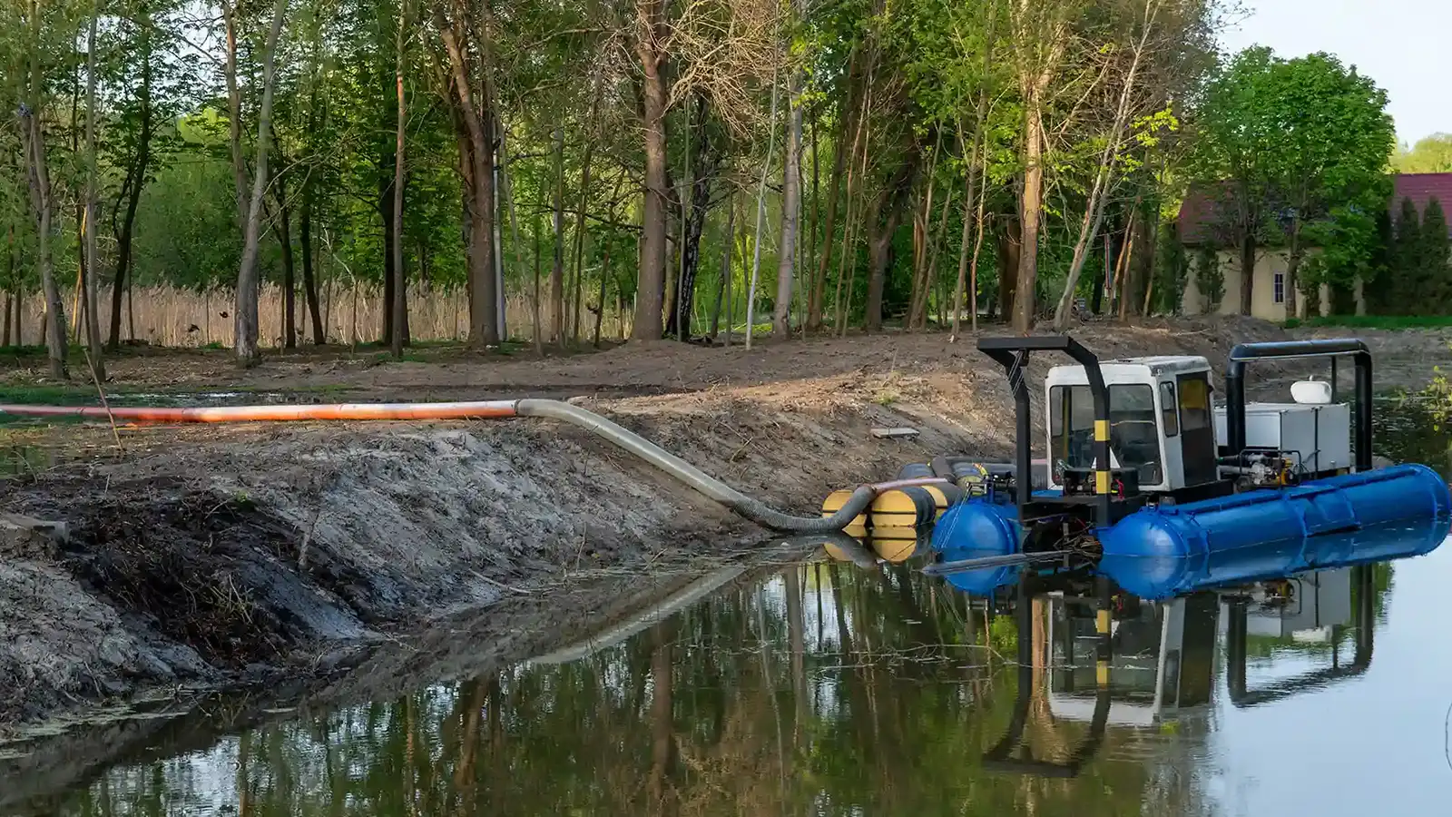 Dredging operation using heavy-duty HDPE pipe and slurry hose to handle abrasive material and high-volume sediment transfer in a marine environment