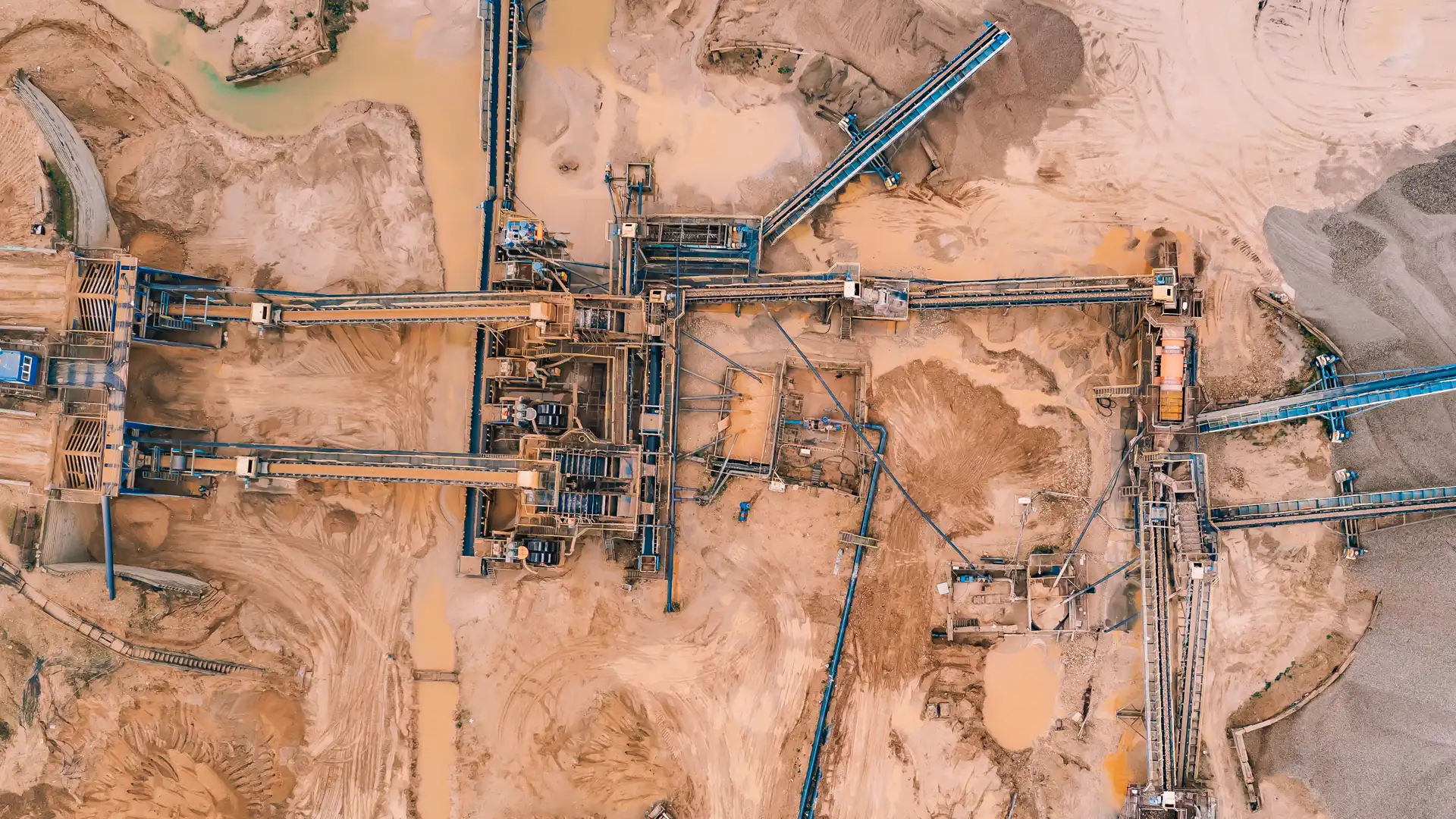 Open-pit mining operation where abrasion-resistant piping handles slurry transport, dewatering, and process water management under extreme wear conditions