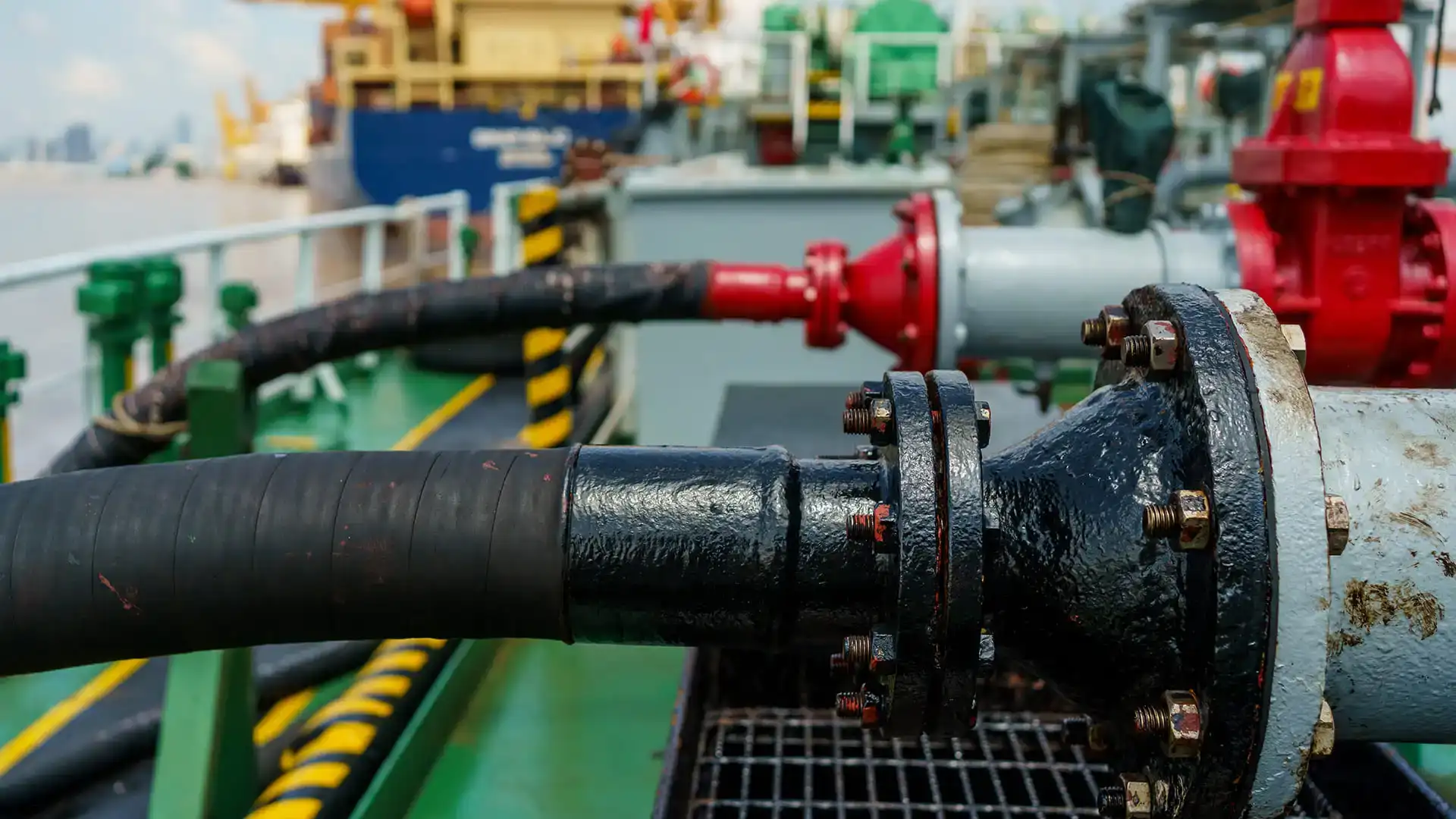 Shipyard and coastal marine facility using corrosion-resistant pipe and hose for fluid handling in high-moisture, saltwater-exposed environments