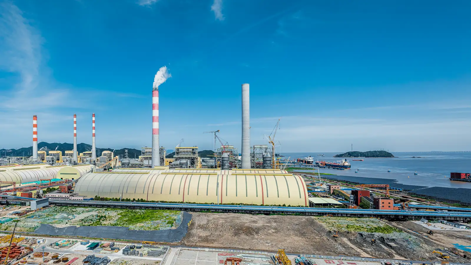 Coastal power plant cooling water intake system showing sediment buildup and pipeline corrosion impacting flow efficiency and performance