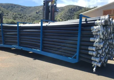 HDPE pipe inventory and fittings stored in industrial yard for rapid deployment to bypass pumping and water transfer projects